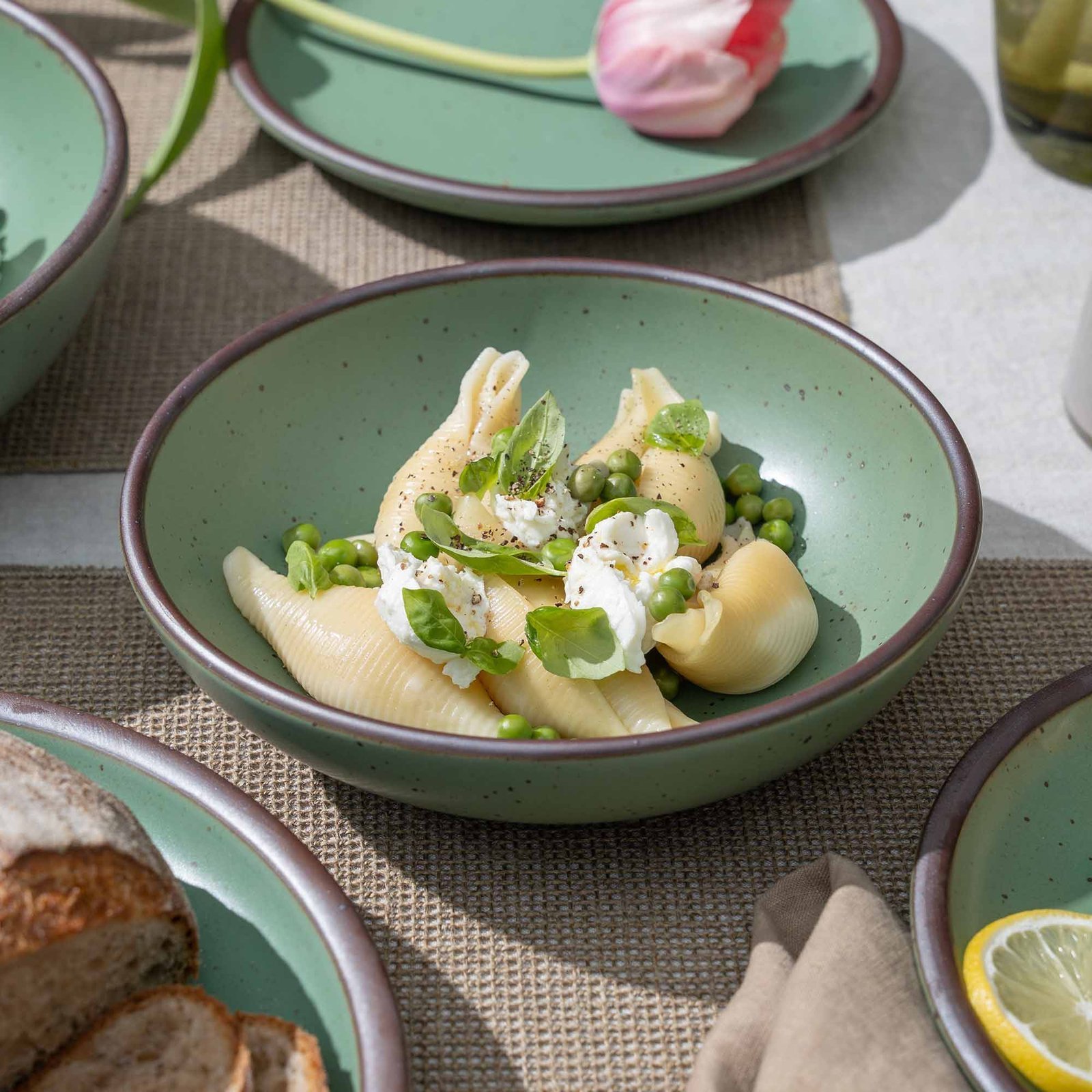 Accooler daily bowl in Viridian, shown with pasta in a table setting
