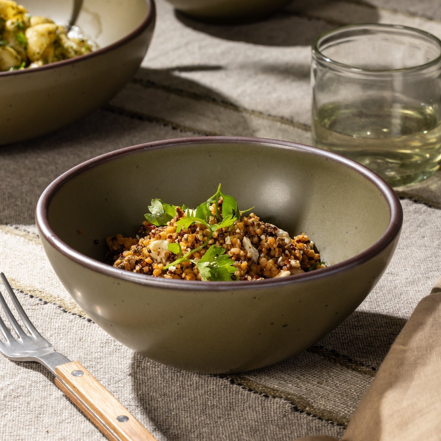 Accooler soup bowl in Pine Green, shown with a grain dish